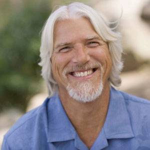 man with white hair and beard smiling